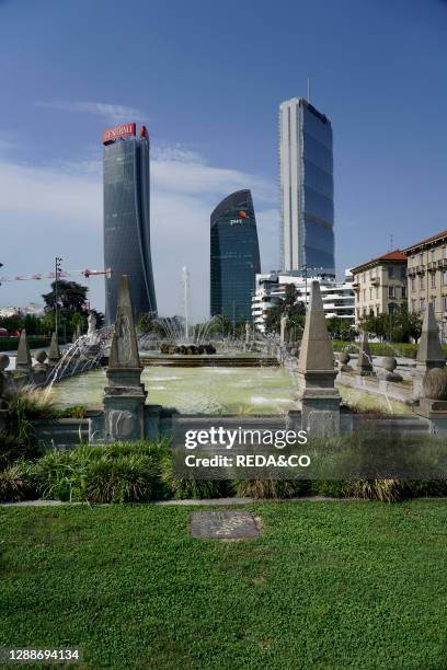 The three towers in CityLife district view from piazzale Giulio Cesare with the Quttro Stagioni fountain, Milan, Lombardy, Italy, Europe.