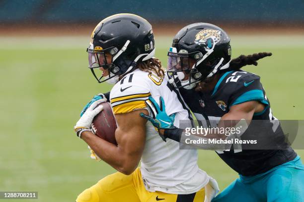 Chase Claypool of the Pittsburgh Steelers makes a catch under pressure from Chris Claybrooks of the Jacksonville Jaguars at TIAA Bank Field on...