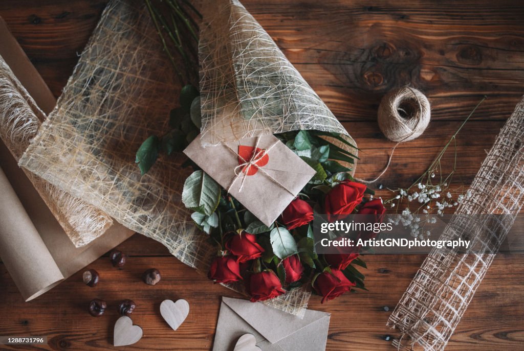 Wrapping bouquet with red roses for Valentines Day.