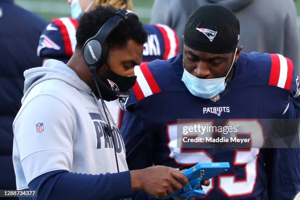 Josh Uche of the New England Patriots talks with inside linebackers coach Jerod Mayo during the game against the Arizona Cardinals at Gillette...