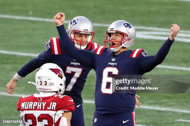 Nick Folk of the New England Patriots celebrates with Jake Bailey after kicking a 50 yard game winning field goal against the Arizona Cardinals...