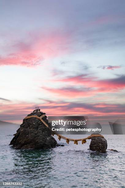 meoto iwa wedded rocks of ise, mie prefecture at sunset - ise mie stock pictures, royalty-free photos & images