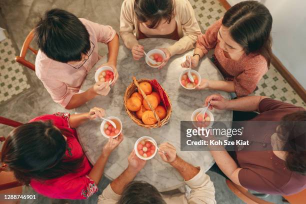 Overhead view of a family eating tang yuan or glutinous rice ball during Chinese New Year