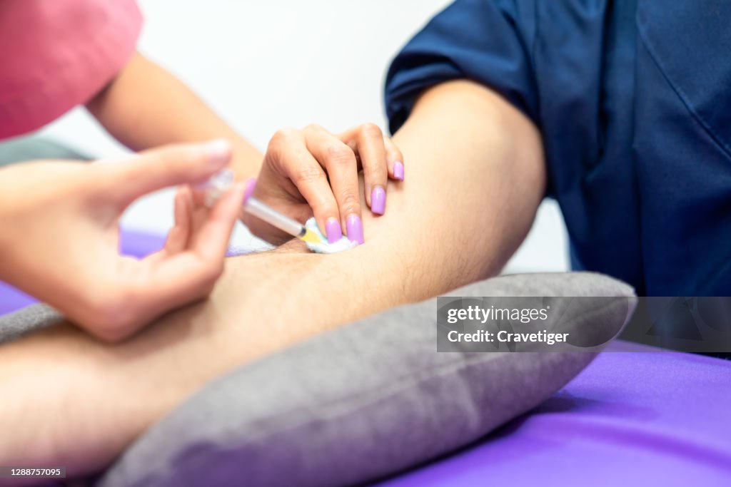 Patient Arm Injection The Patient Receiving An Injection In His Arm High-Res Stock Photo ...