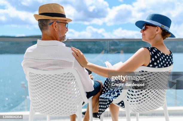 happy couple enjoying the view from a balcony - couple balcony stock pictures, royalty-free photos & images