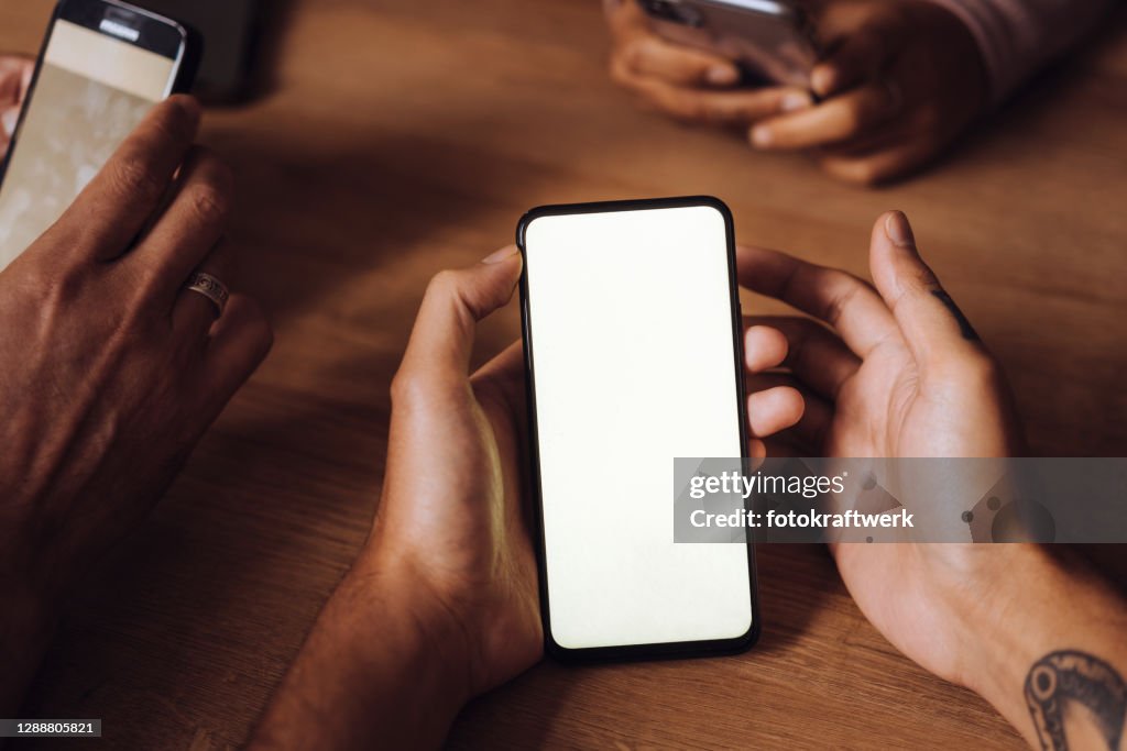 Using Moble Phone Hands Of Friends Using Mobile Phones On Table In Restaurant At Weekend ...