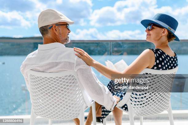 happy couple enjoying the view from a balcony - spartan cruiser stock pictures, royalty-free photos & images