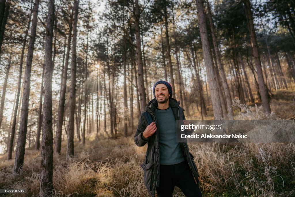 Young man hiking on a cold winter day