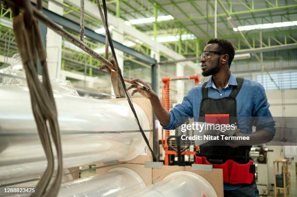 quality control engineer examining plastic roll raw material in production line in a factory. - ear plug stock pictures, royalty-free photos & images