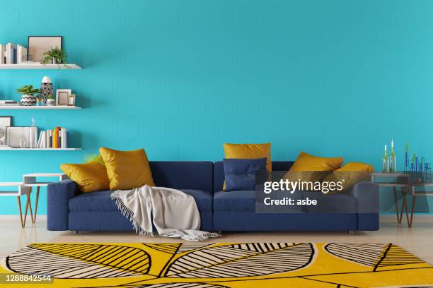 modern living room with sofa and book shelf - blue paint stock pictures, royalty-free photos & images