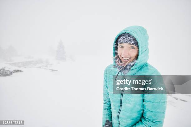 Portrait of smiling woman bundled up in snow storm