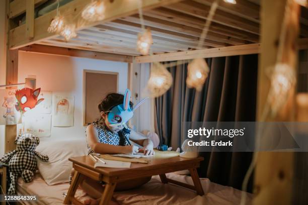 nighttime of cute daughter doing homework-stock photo - kids in bunk bed stock pictures, royalty-free photos & images