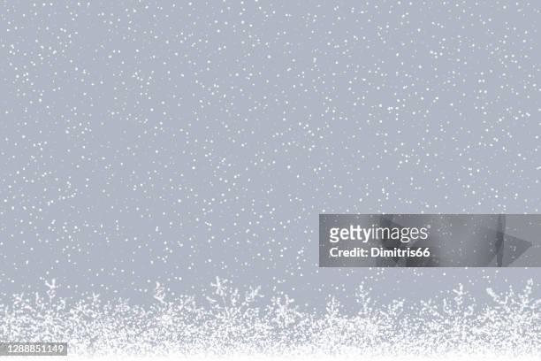 winter background: falling snow and snowflakes at the bottom of a desaturated hazy background. - snow stock illustrations