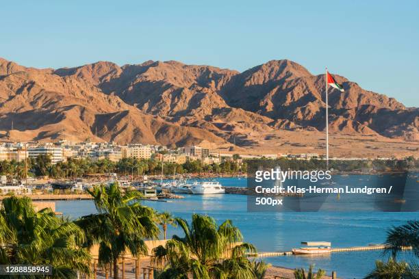scenic view of sea and mountains against clear blue sky,aqaba,jordan - jorden stock pictures, royalty-free photos & images