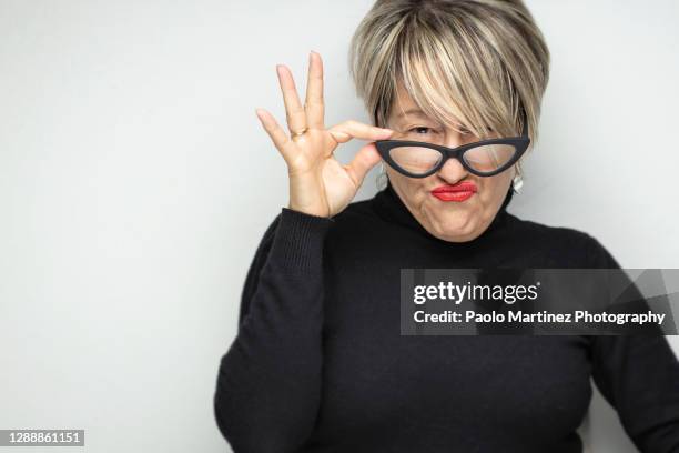 a portrait of a adult woman making a face against white background - bad bangs imagens e fotografias de stock