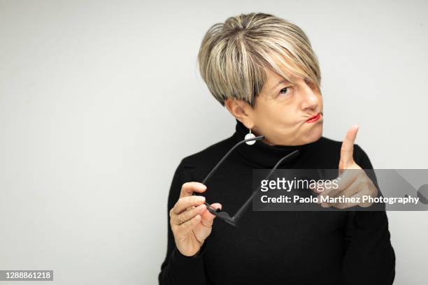 portrait of angry mature woman against white background - shaking finger stock pictures, royalty-free photos & images