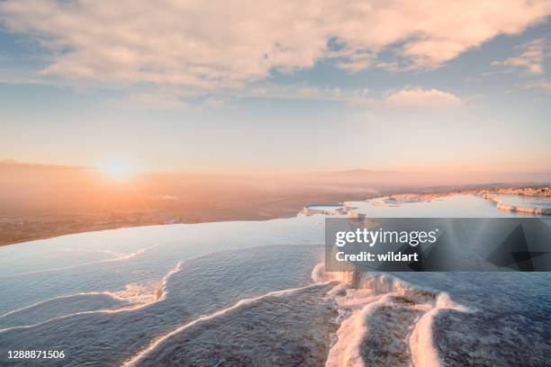beautiful scenic view of travertine pools during sunset in pamukkale in turkey - pamukkale stock pictures, royalty-free photos & images
