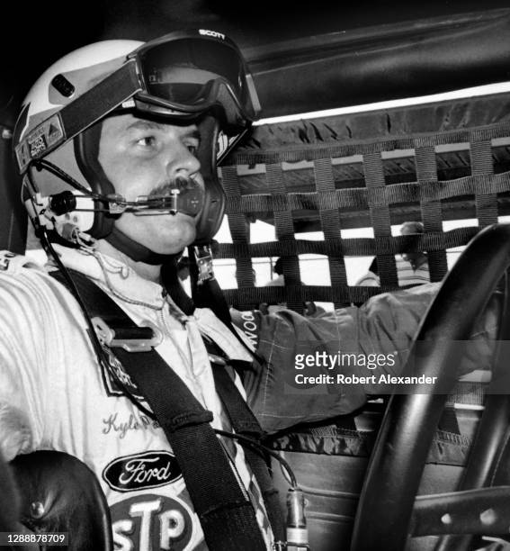 Driver Kyle Petty sits in his racecar prior to the start of the 1987 Pepsi Firecracker 400 stock car race at Daytona International Speedway in...