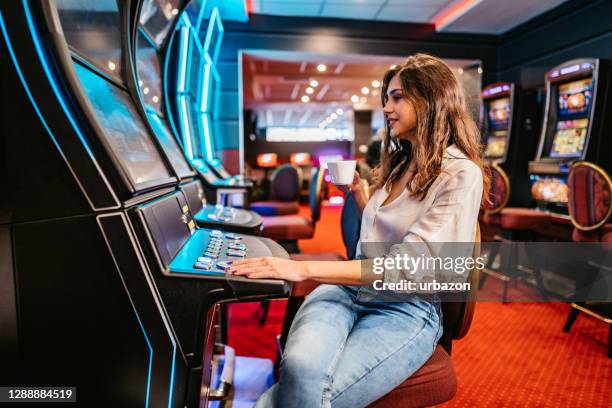 woman playing slot machine in casino - the beat the chic party stock pictures, royalty-free photos & images