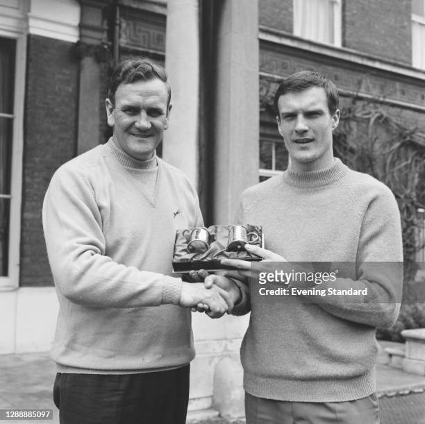 Leeds United manager Don Revie and team member Paul Madeley with two Evening Standard awards, UK, 2nd March 1968.