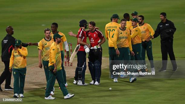 Jos Buttler and Dawid Malan of England celebrate amongst the South Africans after securing England a 3-0 series victory during the 3rd Twenty20...