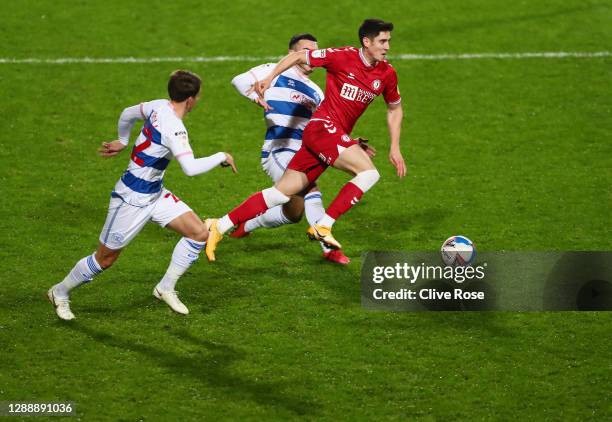 Callum O'Dowda of Bristol City is challenged by Tom Carroll and Ilias Chair of Queens Park Rangers during the Sky Bet Championship match between...