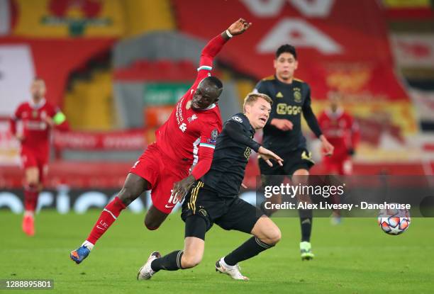 Sadio Mane of Liverpool FC is fouled by Perr Schuurs of Ajax Amsterdam during the UEFA Champions League Group D stage match between Liverpool FC and...