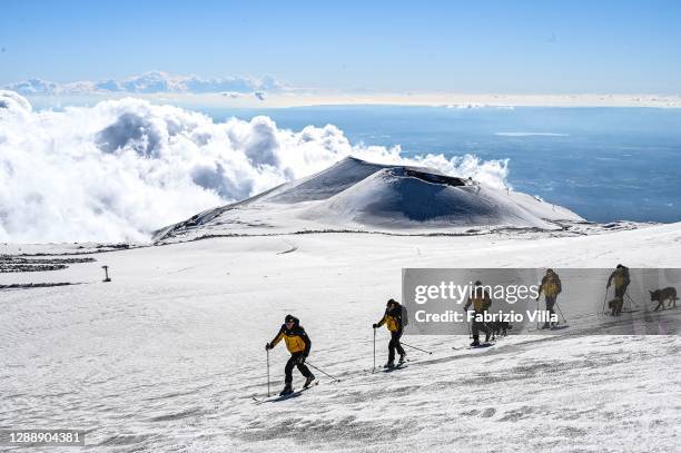 Guardia di Finanza Mountain Rescue soldiers while skiing with rescue and search dogs during a patrol at high altitude control at 2900 meters near the...