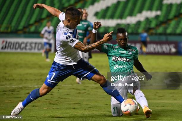 Ricardo Centurion of Velez fights for the ball with Kevin Velasco of Deportivo Cali during a round of sixteen second leg match between Deportivo Cali...