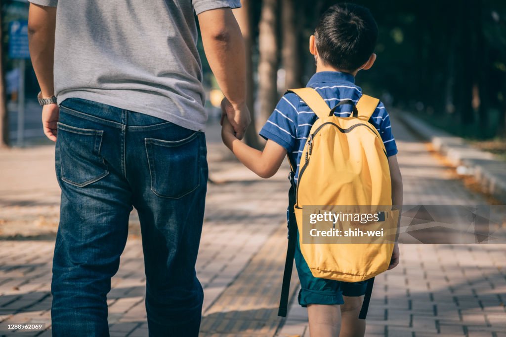 Father and son going to kindergarten