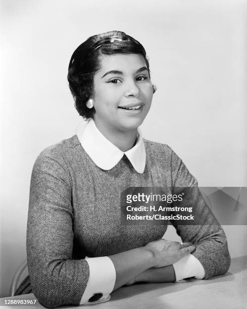 1950s 1960s Portrait Smiling African-American Woman Leaning On Arms Folded On Table Looking At Camera
