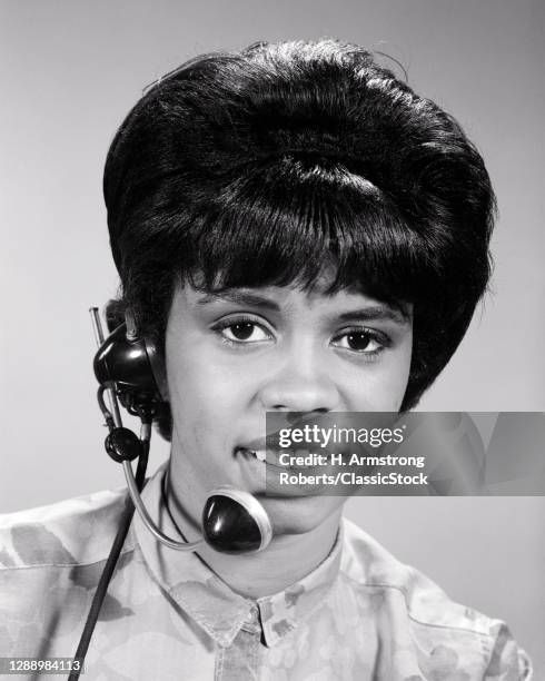 1960s African-American Woman Telephone Operator Receptionist Looking At Camera Speaking Listening Wearing A Headset