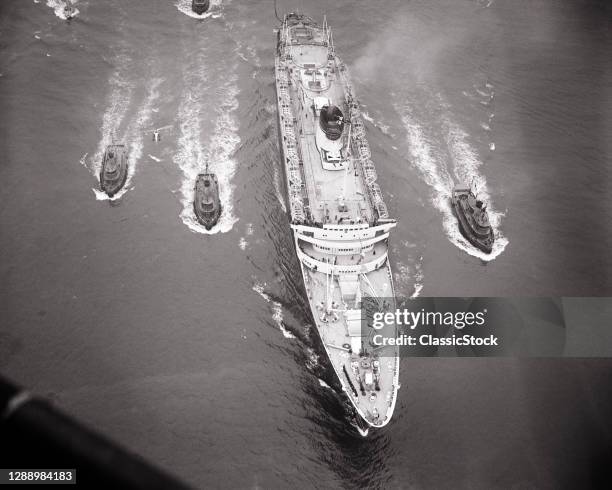 1950s 1953 Arrival Of The Ocean Liner Ship Ss Andrea Doria Into Harbor With Accompanying Tug Boats New York City New York USA