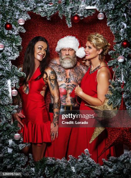 bad ass santa claus with beautiful woman - tattoo (ass) stock pictures, royalty-free photos & images
