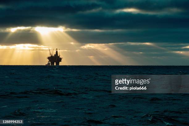 industrial oil rig offshore platform: away from a sustainable resource - crude oil stock pictures, royalty-free photos & images