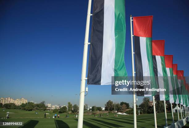 The national flag of the UAE are pictured next to the driving range during Day One of the Golf in Dubai Championship at Jumeirah Golf Estates on...