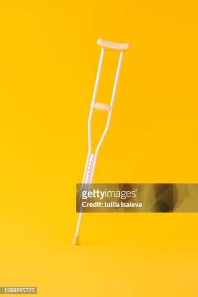 crutch near crop person with plaster bandage - crutch stock pictures, royalty-free photos & images