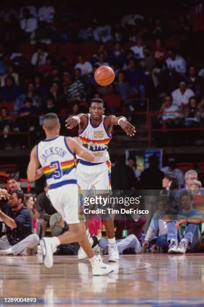 Dikembe Mutombo, Center for the Denver Nuggets passes the basketball to Mahmoud Abdul-Rauf during the NBA Midwest Division basketball game against...