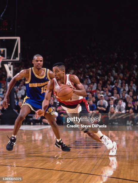 Rod Strickland, Point Guard and Shooting Guard for the Portland Trail Blazers dribbles the basketball by Latrell Sprewell of the Golden State...