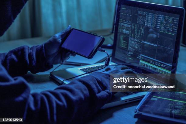 hacker using laptop. lots of digits on the computer screen. - surveillance imagens e fotografias de stock