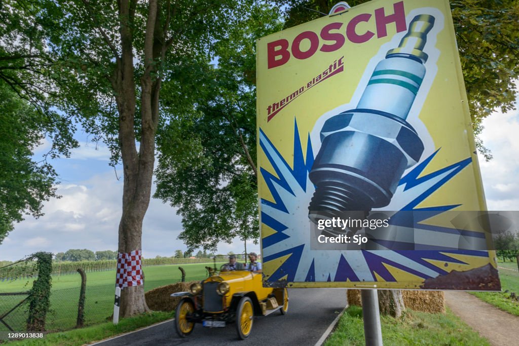 Bosch spark plug classic advertisment poster with a vintage car driving past