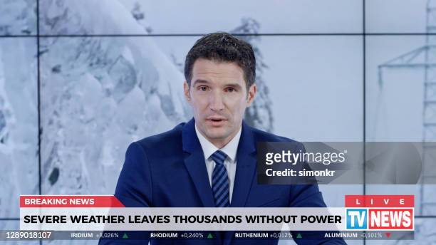 male anchor presenting breaking news about severe weather causing power outage - breaking news stock pictures, royalty-free photos & images