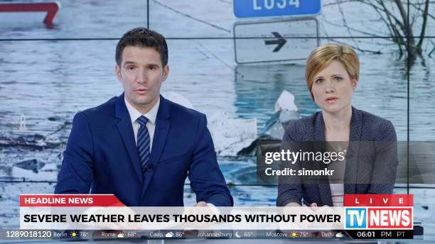 anchors presenting breaking news about severe weather causing power outage - breaking news stock pictures, royalty-free photos & images