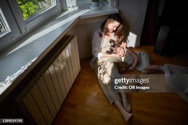 smiling mother and daughter relaxing at home - tranquility family stock pictures, royalty-free photos & images