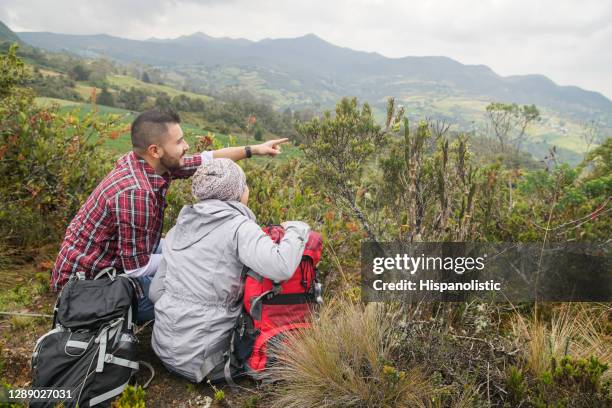 happy couple hiking in colombia and looking at the beautiful paramo - eco tourism stock pictures, royalty-free photos & images