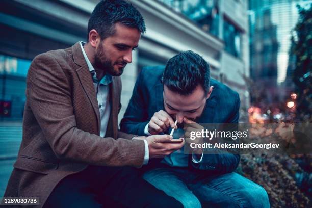 males getting into bad habits snorting cocaine outside on a night out - drugs cocaine stock pictures, royalty-free photos & images