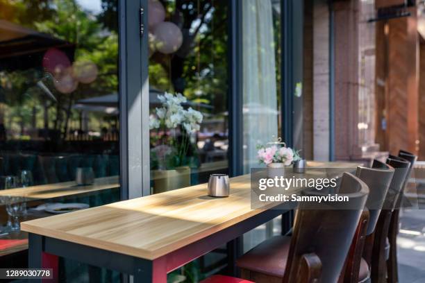 close-up of empty table at sidewalk cafe - cafe seating stock pictures, royalty-free photos & images