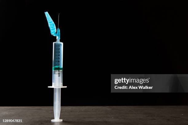 syringe with safety needle on black background - behållare för farligt avfall bildbanksfoton och bilder