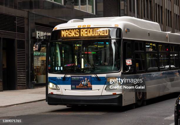 An MTA bus displays 'Masks Required' on the front of the bus as the city continues the re-opening efforts following restrictions imposed to slow the...