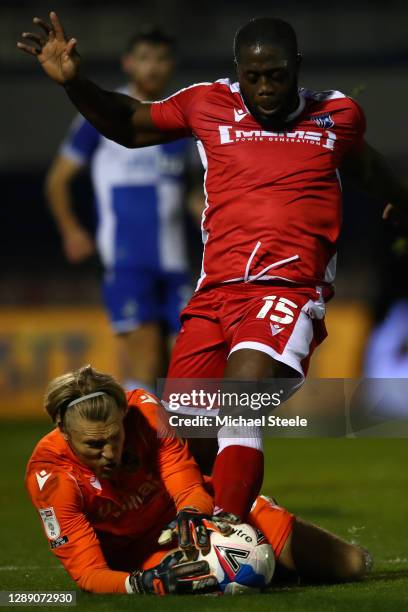 John Akinde of Gillingham challenges for the ball as goalkeeper Anssi Jaakkola of Bristol Rovers smothers during the Sky Bet League One match between...